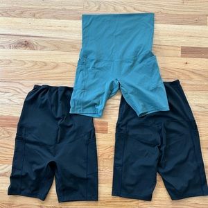 Women’s maternity biker shorts size medium. Two in black and one in green.